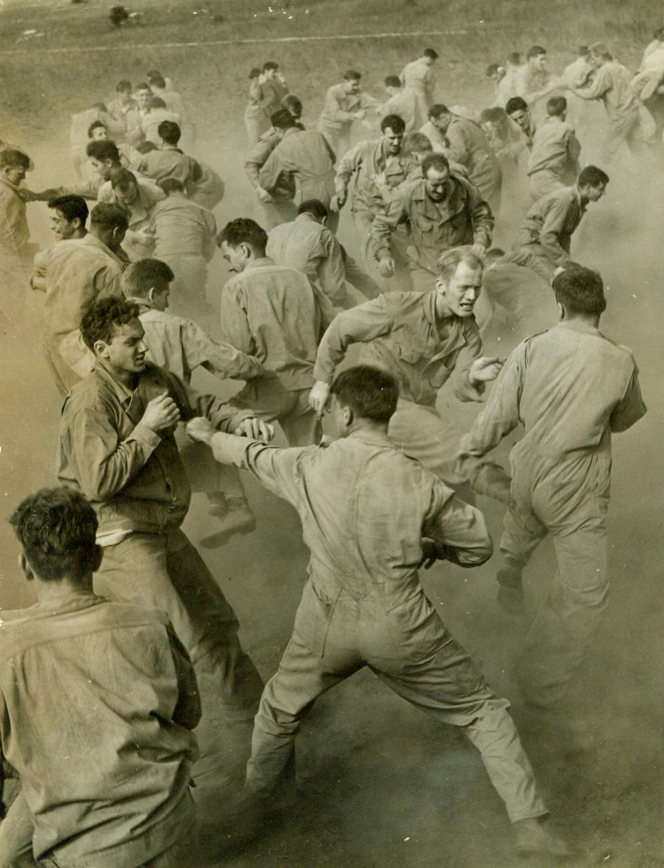 Potential rangers undergo training, 9/25/1942. FORT GEORGE G. MEADE, MD. – Kicking up the dust trainees under the instruction of Major Franco O’Eliscu are undergoing rigorous workouts in preparation for ranger attacks against our enemy. Here the group engages in hand to hand combat. CREDIT LINE (ACME) 9/25/42;