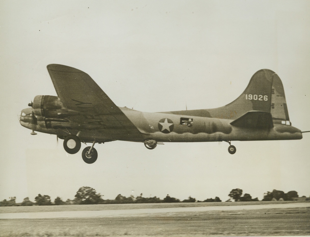 MIGHT ON THE WING, 9/11/1942. ENGLAND—Bristling with guns and mottled with camouflage, a U.S. “Flying Fortress” heavy bomber roars aloft in a take-off from an American Bomber Training Station “somewhere in England.” Credit Line (ACME);