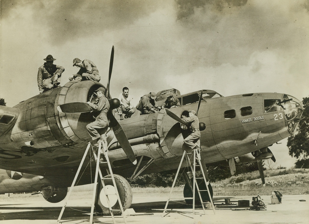 Skilled Technicians On The Ground, 9/11/1942. England – Skilled technicians of the ground crew at a U.S. Bomber Training Station “somewhere in England” service a deadly Flying Fortress heavy bomber of the U.S. Army Air Forces. Passed by censors. Credit: ACME;
