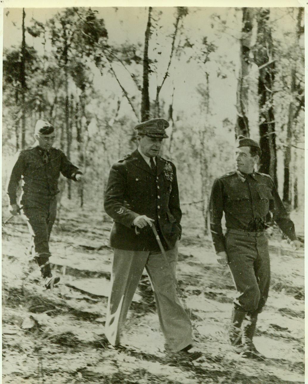 MacArthur Goes on Inspection Trip, 9/6/1942. General Douglas MacArthur (center) walks with officers of an American Division during an inspection trip “somewhere in Australia”.  9/6/42 (ACME;