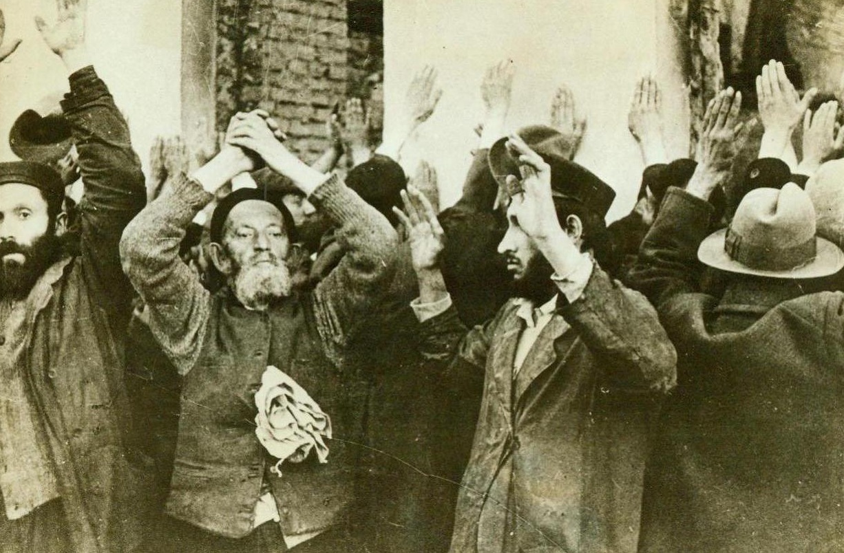 Jews Rounded Up In Warsaw, 9/10/1942. Warsaw, Poland -- Under the threat of Nazi guns, these defenseless Jews hold their hands high and line up against a wall, during a round-up in Warsaw's Ghetto. Out of Nazi-occupied Poland have come horrible tales of torture and separation of family units suffered by the Jews at the hands of the hated Gestapo. Photo was found on the body of a German officer, evidently a participant in this round-up, who was killed before Moscow 9/10/42 (ACME);