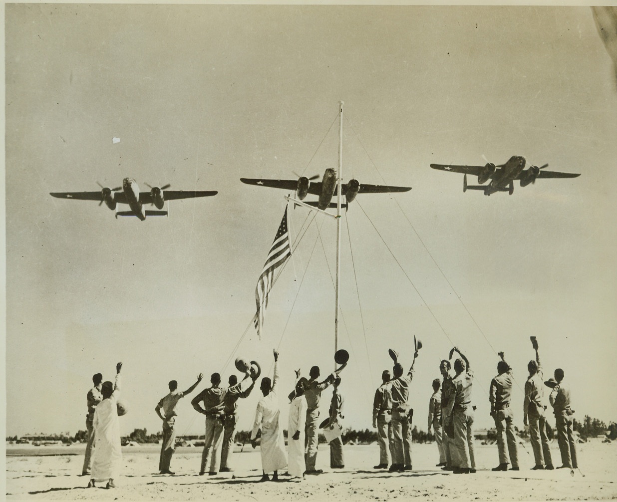American Bombers Get Welcoming Committee, 9/12/1942. Middle East – Three U.S. medium bombers, B-52’s, get an enthusiastic welcome from their American ground crews after they have blasted Axis bases in the Middle East. The boys in native costume are mess attendants at the U.S. station. Credit: (ACME);