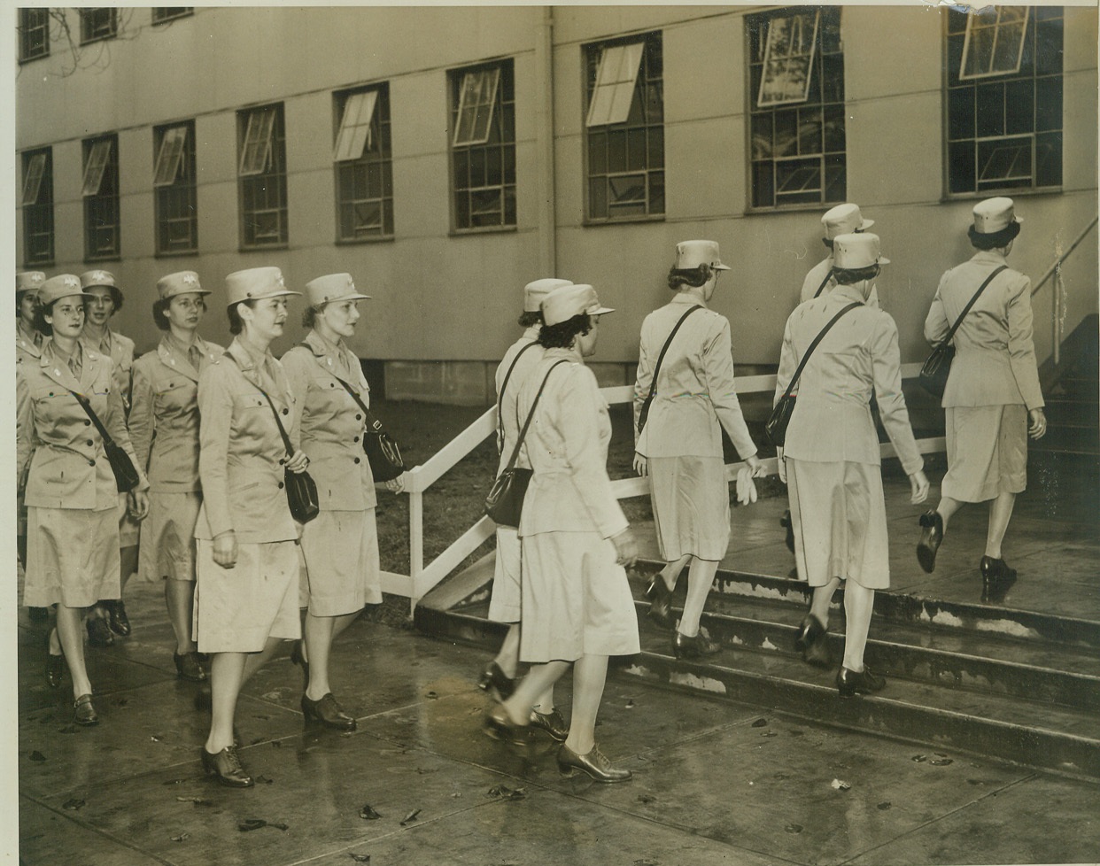 The WAACS Take Over, 9/18/1942. Washington, D.C. – A group of WAACs march into one of the War Department’s temporary buildings as they reported for duty on Sept. 18th to take the place of male officers in office work. Credit: (ACME);