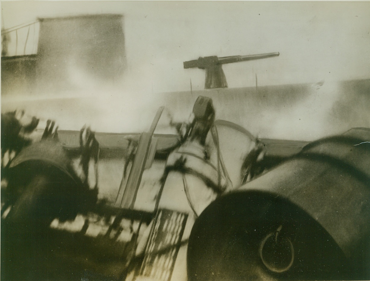 CANADIAN DESTROYER GETS A NAZI SUB, 9/19/1942. OTTAWA – Somewhere in the Atlantic the Canadian destroyer Assiniboine tangled with a German submarine and when the fog had lifted, the destroyer had rammed and sunk the sub, and captured most of the crew. Above dramatic picture was made as the submarine, gun and part of hatch seen in background slithered off the destroyer, part of rear of which can be seen in foreground. Credit: ACME;