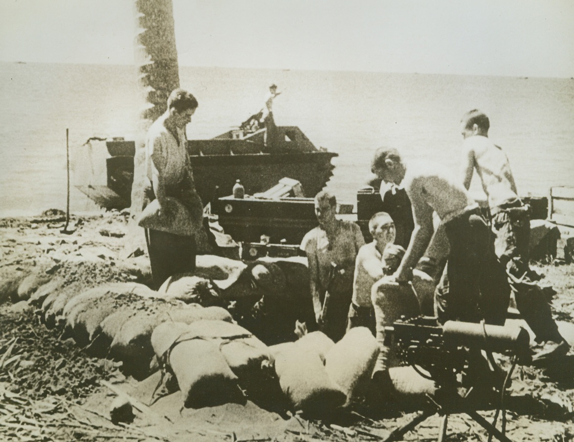 “Digging In”, 9/8/1942. SOLOMON ISLANDS—U.S. Marines establish positions on a beach in Guadalcanal after the opening battle of the first American offensive of World War II. The amphibian tractor, in the background, churned the South Seas waters to bring these marines ashore. Credit: U.S. Marine Corps photo from News of the Day supplied by ACME;