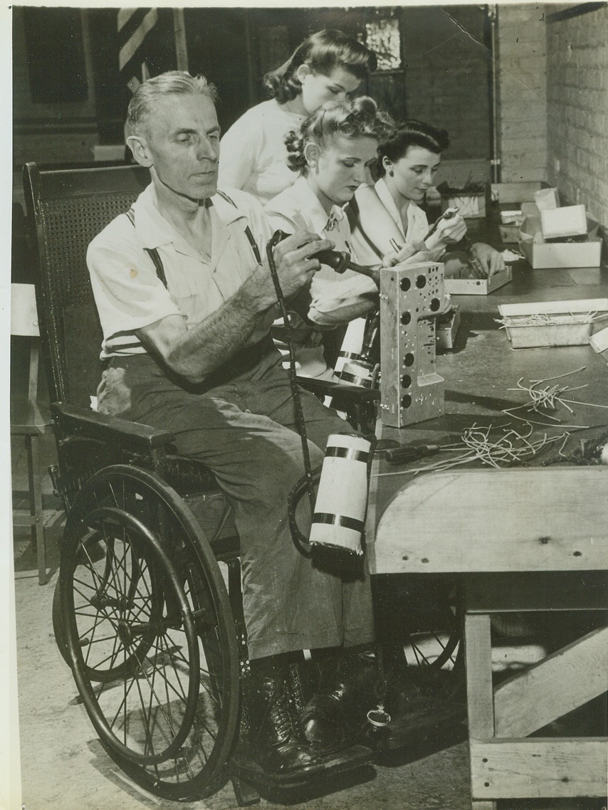Chicago Bureau, 9/8/1942. CHICAGO, ILL. -- Although confined to a wheelchair, Albert Wiese, 54, infantile paralysis victim, works daily in a Chicago radio plant making radios for the Army and Navy. Your Credit: must read ACME;