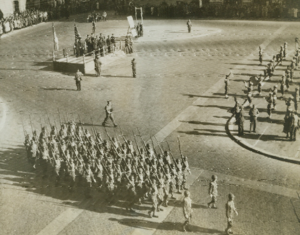 Celebrate Armistice Day in Rome, 11/11/1944. Italy—Marching in cadence Allied armed forces parade in Piazza Venezia, Rome, during ceremonies commemorating the anniversary of Armistice Day. Credit: OWI radiophoto from ACME.;