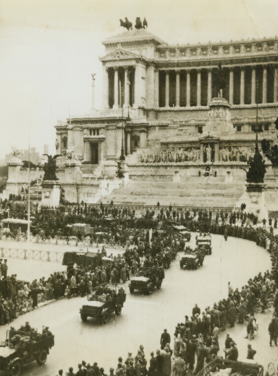 Italian Troops Parade in Rome, 11/25/1944. ROME – Jeeps filled with Italian troops roll past the imposing Victor Emanuel Memorial in Rome during a parade in which they were reviewed by Prince Umberto. These soldiers of Italy now march as free men no longer under Fascist rule and go into battle against their former Axis partner, Germany, willingly.Credit (OWI Radiophoto from Acme);