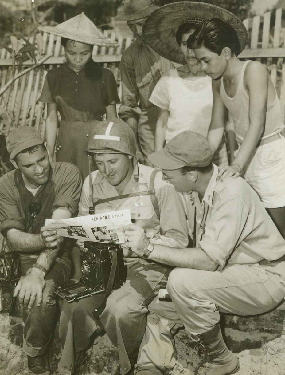 ACME Cameraman Reported Killed, 11/14/1944. Leyte, Philippines – This is probably one of the last photos of ACME Correspondent Frank Prist, Jr. (center) who has been reported killed in the Philippines.  With him reading inter-office paper are Stanley Troutman (left) and Tom Shafer (right), who are also covering the U.S. offensive on Leyte.Credit Line-WP-(ACME photo by Stanley Troutman, War Pool Correspondent);