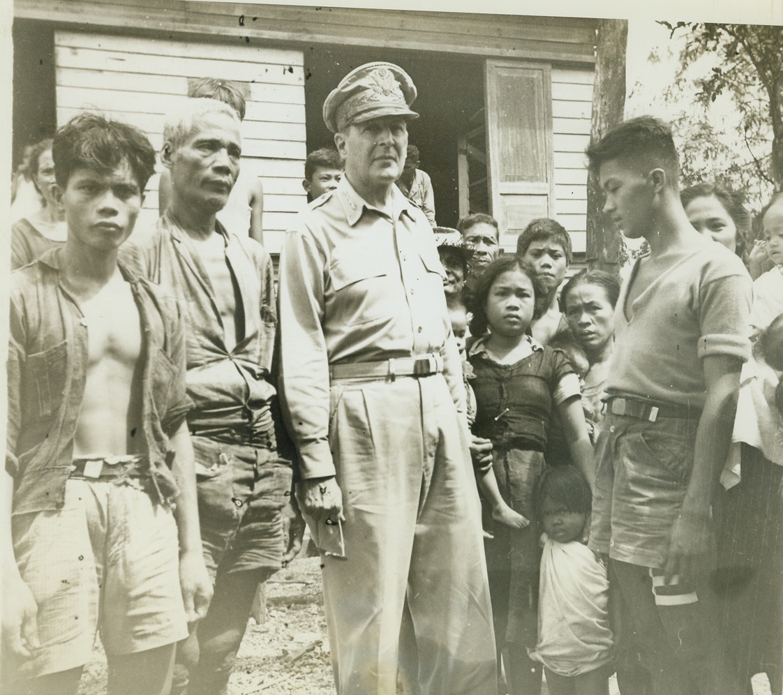 "Mac" Returned to Free Them, 11/1/1944. LEYTE ISLAND, PHILIPPINES -- Anxious to greet their liberator, Filipinos cluster around General Douglas MacArthur, who made good his promise to return and free the Islanders. Photo by ACME Photographer Thomas L. Shafer for the War Picture Pool.  Credit: (ACME) -- WP;
