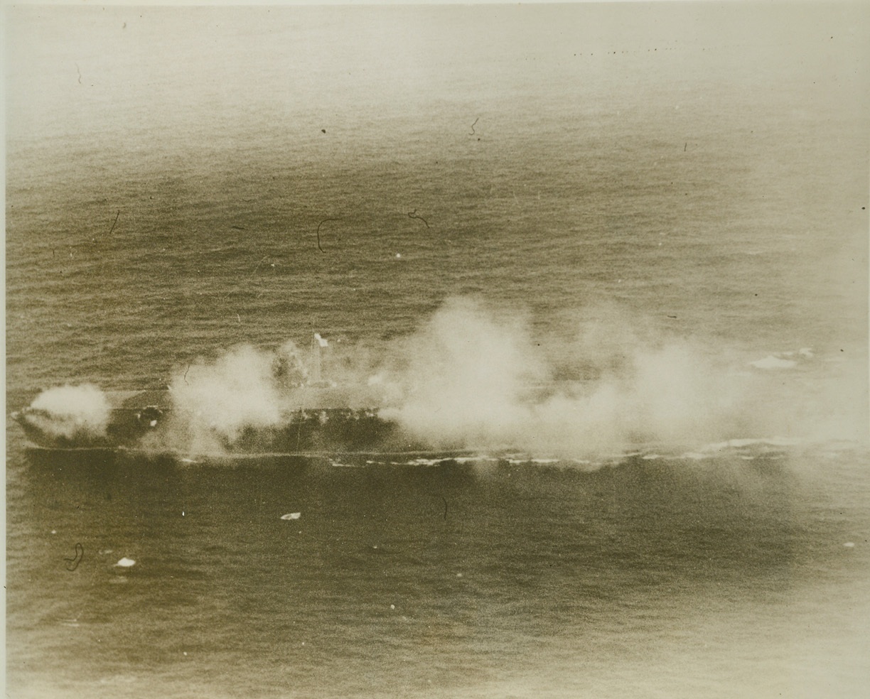 The Bitter End, 11/1/1944. Philippines—Aflame from stem to stern, this light carrier of the Jap Navy’s Chitose glass lies dead in the waters off Luzon, Philippines. The ill-fated vessel was attacked by carrier forces of the U.S. Pacific fleet. Credit: U.S.S. Navy photo from ACME.;