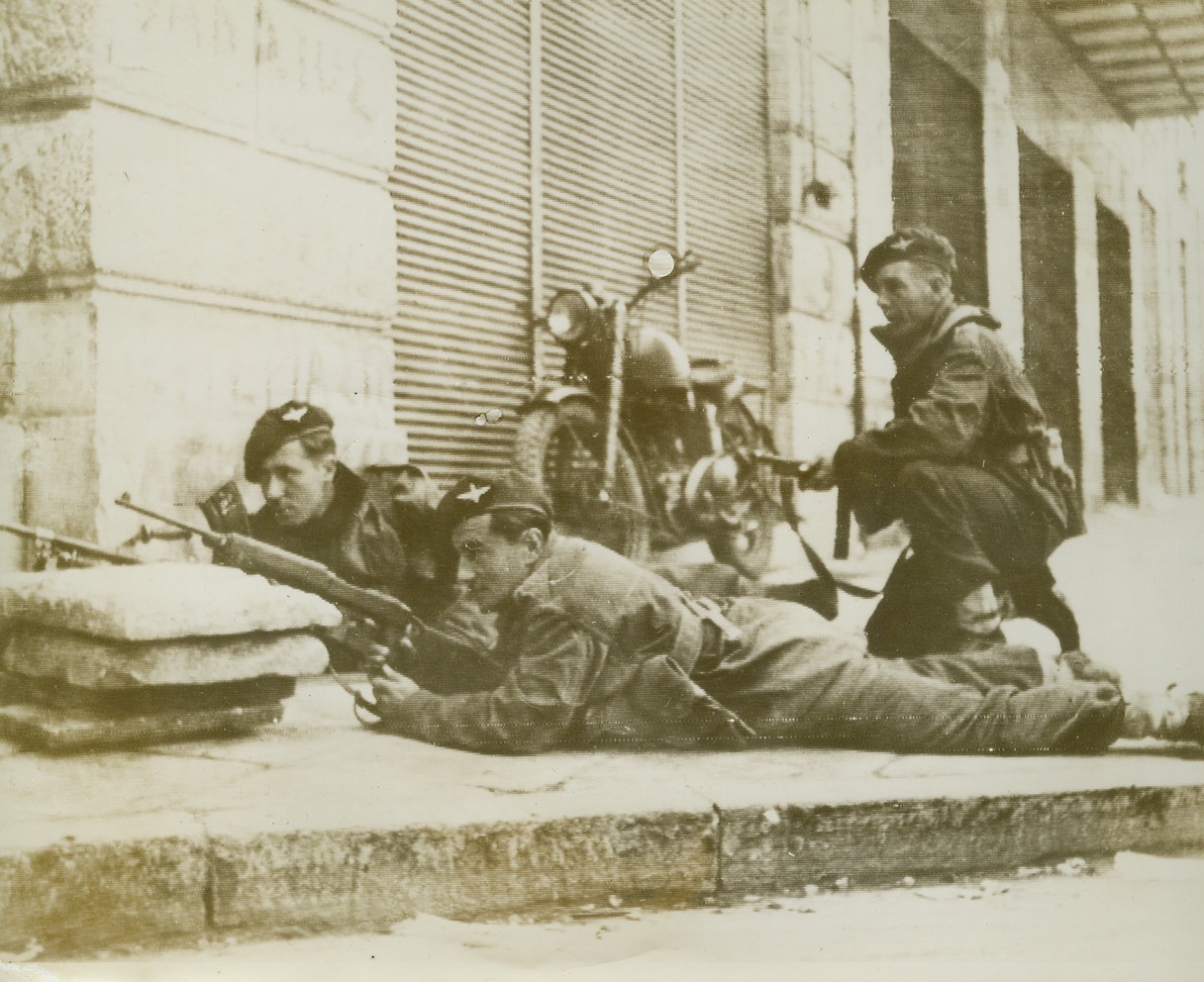 British Troopers Battle Rioters, 12/11/1944. Athens, Greece—Taking their stand behind a paving block barricade, British paratroopers stand guard during the recent riots in Athens. The British forces succeeded in beating back an attempt by the (illegible word) to capture the center of the city yesterday (Dec. 10).  Credit: British official photo via OWI from ACME.;