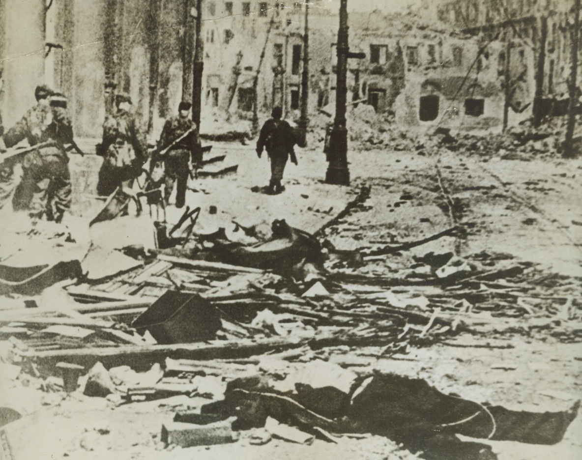 Devastated Poland Still a Battle Field, 12/2/1944. POLAND – A German patrol in the center of Warsaw passes through a street that was the scene of bitter battles by Polish patriots against overwhelming odds. This dramatic new picture from a neutral source shows the full extent of the ruin and tragedy which the premature rising, quelled when the Red Armies were stopped at the gates of the Polish capital, brought upon Warsaw.Credit Line (Acme);
