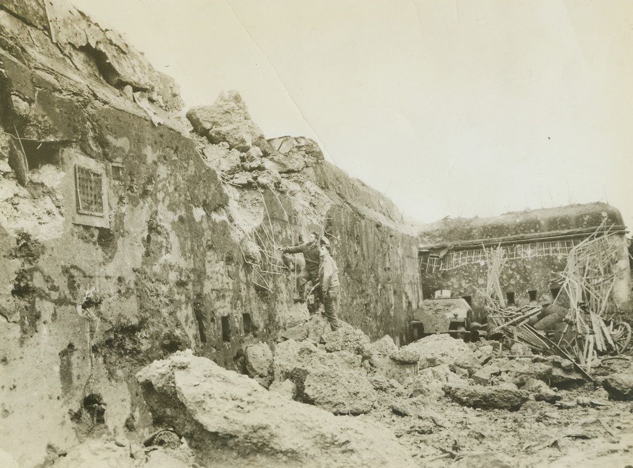 What Our Guns Did To German Fort,12/19/1944. Metz, France – Soldiers of the Fifth Infantry Division, Third Army, examine the crushed casement of Fort Defiant, a key offense at Metz. The fort was the scene bitter fighting before Yanks succeeded in driving the Germans out. Credit: ACME;