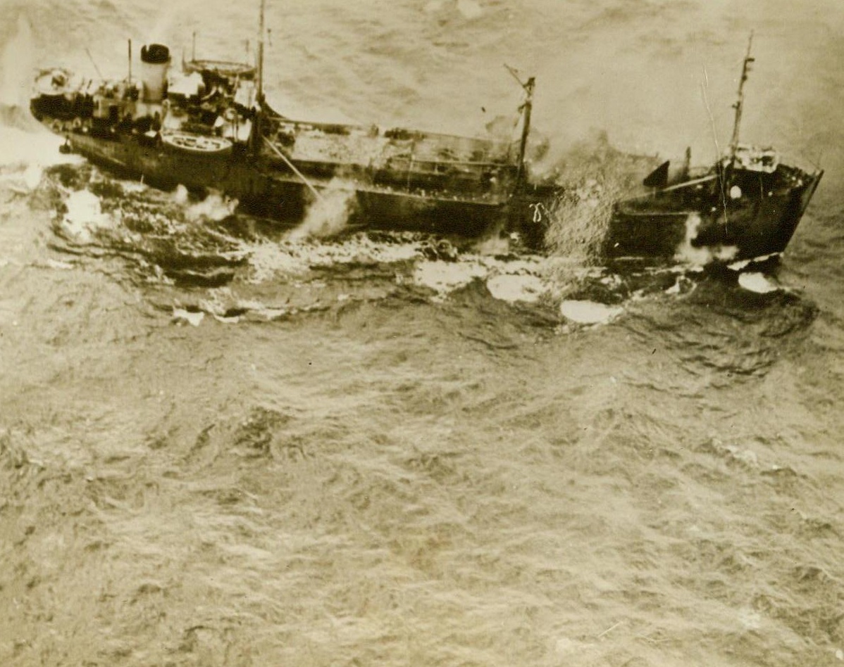 Jap Freighter Under Fire, 12/6/1944. Marshall Islands—Bombs spill form a U.S. Navy carrier-based plane, aimed at a frantically dodging Jap firefighter near Maloelap Atoll in The Marshalls. Forward gun on the ship appears to be an antiquated field gun, still mounted on wheels. The delapitated condition of the vessel indicates that the Japs are feeling a pinch for adequate ships to supply their thinly spread-out supply lines in the Pacific.  12/6/44 (ACME);