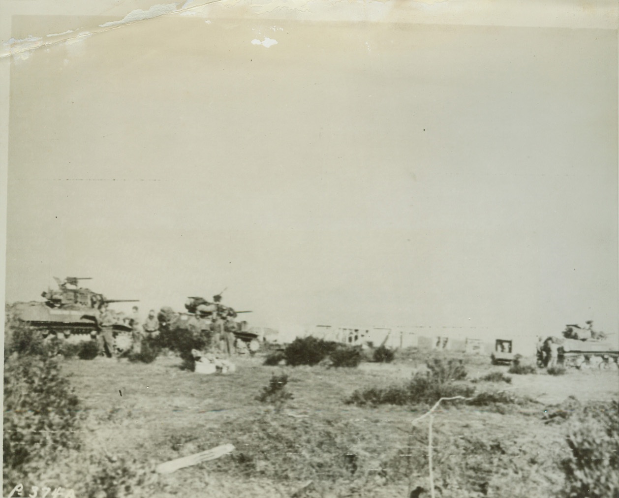 Short cut to Rome, 1/24/1944. Italy – In this photo flashed to the United States by Radiotelephoto today, American Army light tanks stop far inland from the beachheads captured by the Allies in their “shortcut” landings south of Rome. Reason for the halt (above) are the concrete barriers (center background) put up the enemy. Today, it was announced that Allied Forces have driven four miles inland and are less than 30 miles from Rome. They have still encountered little resistance from the Germans. Credit: (U.S. Signal Corps Radiotelephoto from ACME);