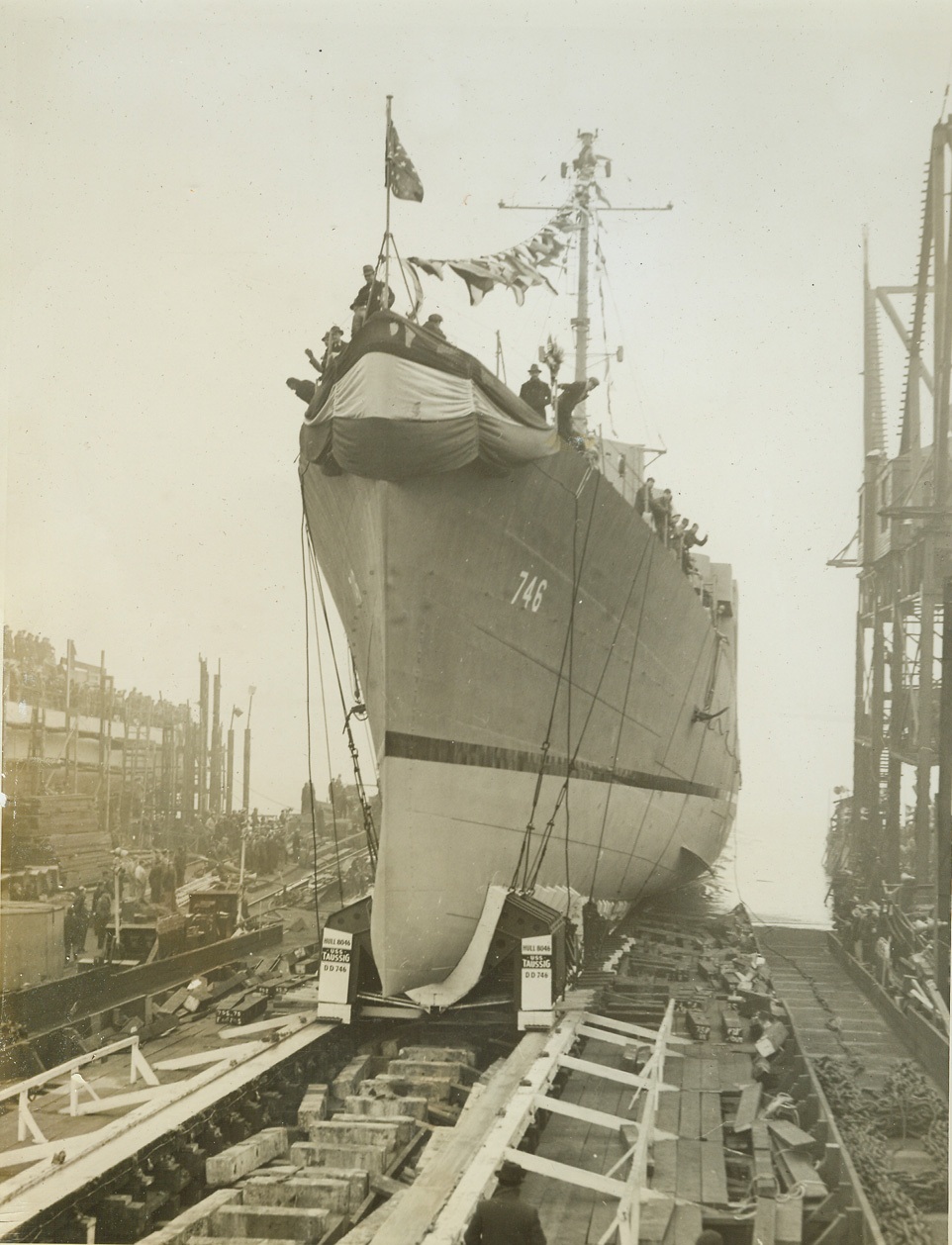 Destroyer Taussig Launched, 1/25/1944. STATEN ISLAND, N.Y. – The 2,200-ton super destroyer U.S.S. Taussig, named after the late Rear Admiral Edward David Taussig, whose heirs have also made naval history, slides down the ways at the Staten Island yard of the Bethlehem Shipbuilding Corp. With the striking power of a World War one cruiser, the U.S.S. Taussig has been designed largely for action in the Pacific as a “Jap-buster”. Credit: (ACME);