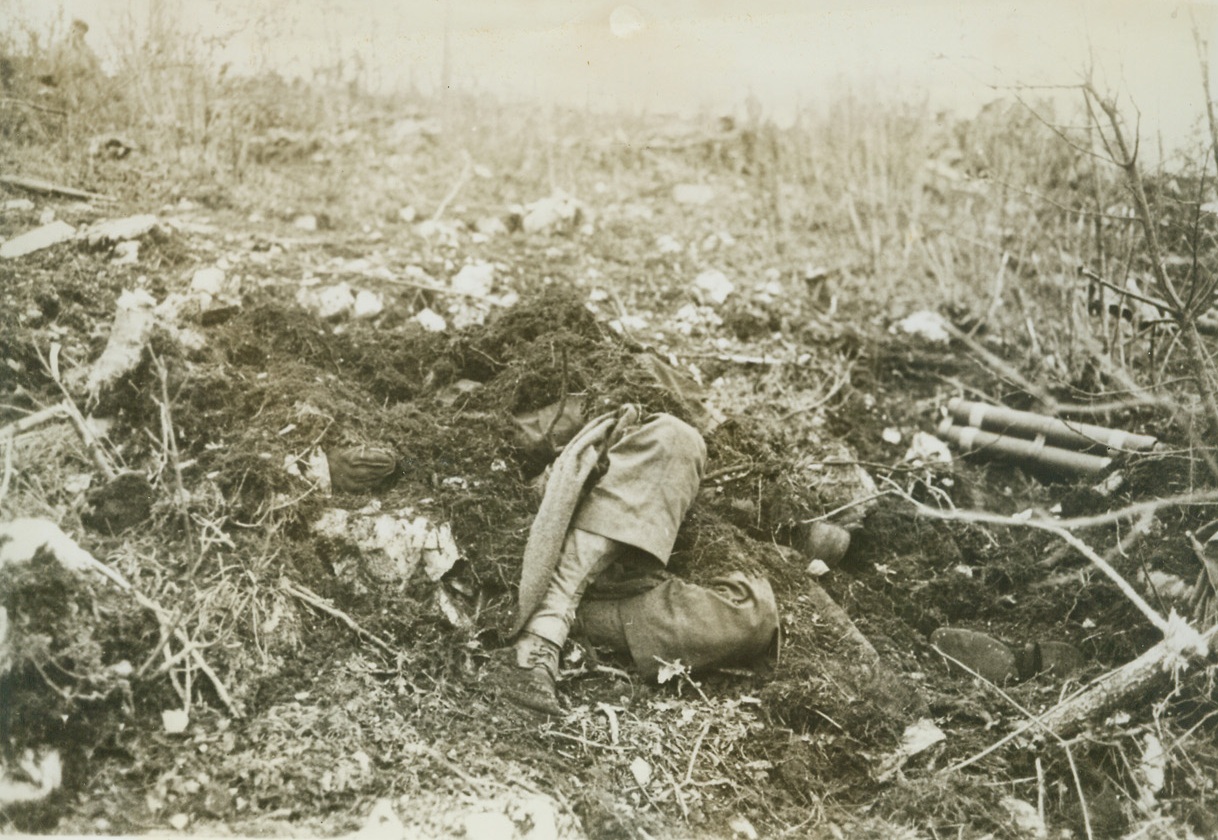 The Americans "Hold Out", 1/22/1944. Italy – Dead American Fighters are covered with brush and clothing by French relief troops who marveled that the yanks could “hold out” on the blasted mountains above the Cassino Valley. Enemy mortar fire reportedly ripped almost every square yard of the slope, and it looks as though this lost crew suffered a direct hit on their emplacement.  When this photo was made a U.S. Fifth Army burial party was on the way.Credit:  ACME;