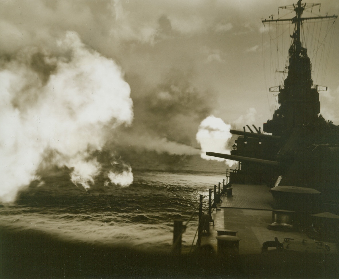 SHAKEDOWN CRUISE, 1/26/1944. AT SEA—A vital part of the training of men who fight at sea is the shakedown cruise, the run on which embryo sailors try their sea legs, get acquainted with their shipmates, and learn how to operate their ship. Here, six-inch guns blast forth in a cloud of smoke and flame, manned by Navy fighters making their shakedown cruise.Credit: Official U.S. Navy photo from Acme;
