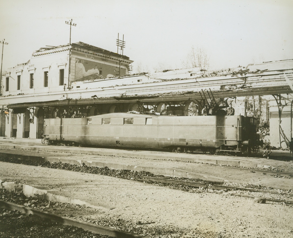 Yanks Get Musso’s Armored Car, 1/25/1944. NAPLES, ITALY—This deluxe, super-armored and armed railway was presented to Mussolini by Hitler, (In the “Good, Old Days”, of Course!). Germans tried to wreck it when the Allies chased them out of the Naples area—but the Yanks were too fast for them and nabbed the “battle-proof Pullman”. It has been put to use as a mobile anti-aircraft gun mount and an American crew of 10 lives in the luxurious quarters meant for Mussolini. Here, Yanks man the quadruple gun mounts at each end of the car during a practice alert.  Credit: U.S. SIGNAL CORPS PHOTO FROM ACME.;