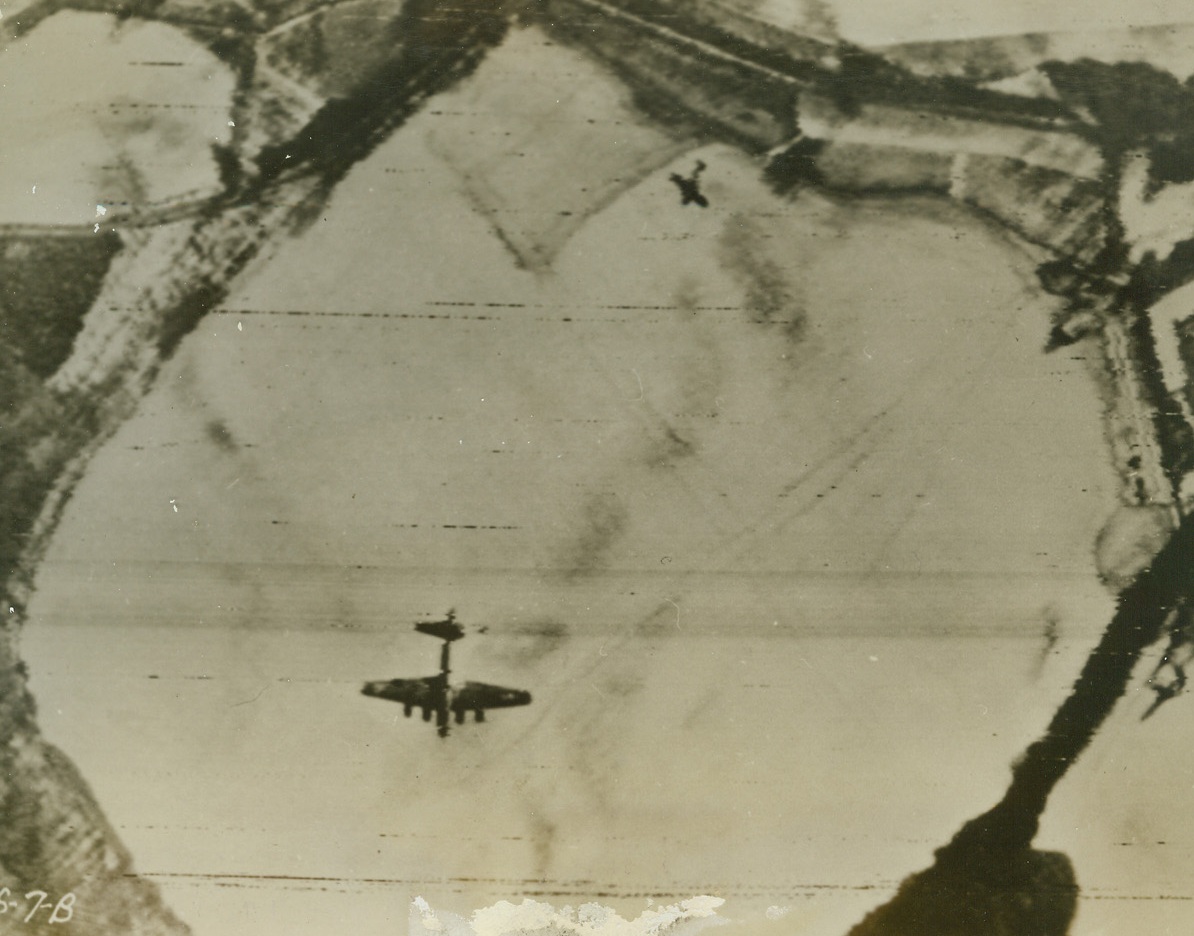 Personal Revenge, 1/14/1944. Probably this FW190, viciously attacking a blazing Flying Fortress (center, bottom), was assembled in the plane plant at Oschersleben, where the B-17 just laid its eggs. The Nazi fighter plane goes in for the kill, as the smoking bomber goes down, during the spectacular January 11th raid when we virtually obliterated three fighter plane assembly plants. Credit: U.S.A.A.F. photo via SIGNAL CORPS TELEPHOTO from ACME RADIOPHOTO.;
