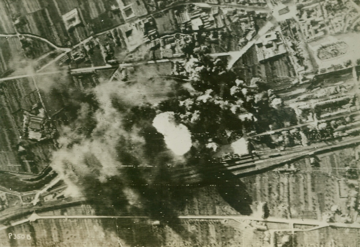 Prato Yards go up in Smoke, 1/5/1944. PRATO, ITALY—As high explosives of raiding American B-26 bombers find their mark, an axis oil dump and the marshalling yards at Prato go up in a mass of smoke and fire came so high that he thought it would reach “right up to meet us at 10,000 feet.” Credit: SIGNAL CORPS RADIOTELEPHOTO from ACME.;