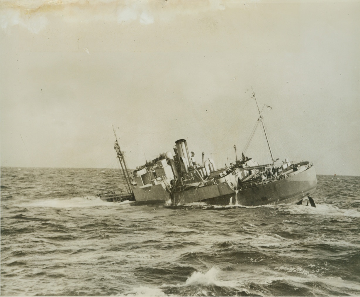 Headed For Davy Jones' Locker, 1/19/1944. NORTH ATLANTIC -- Here is the Army freighter Nevada, pictured during her last few moments from the deck of the Coast Guard Cutter Comanche. The Comanche managed to rescue 29 survivors from the sinking ship which went down during a violent gale off the North Atlantic Coast last month. Thirty-four men were lost, including the Nevada's commanding officer, Captain George P. Turiga of Beacon, N.Y. Credit: (Official Coast Guard Photo - ACME);