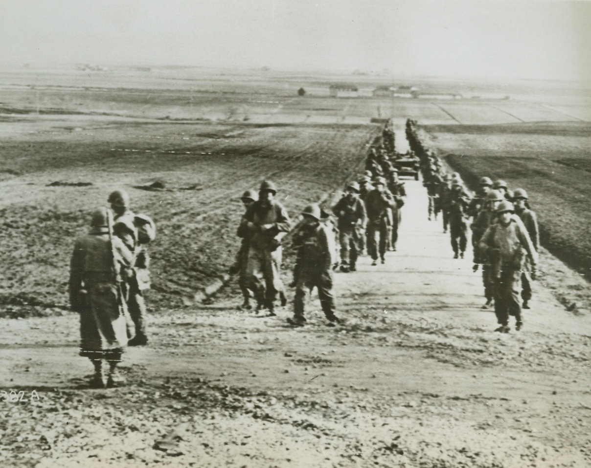 WIDE OPEN AND PLENTY DANGEROUS, 1/29/1944. NETTUNA, ITALY—Fifth Army troops move a few miles inland from their beachheads established near Nettuno, on the road to Rome. Flat level plains are the battlegrounds where the Allies are making slow but sure progress toward their goal.Credit: Acme photo by Bert Brandt, via Signal Corps Radiotelephoto;