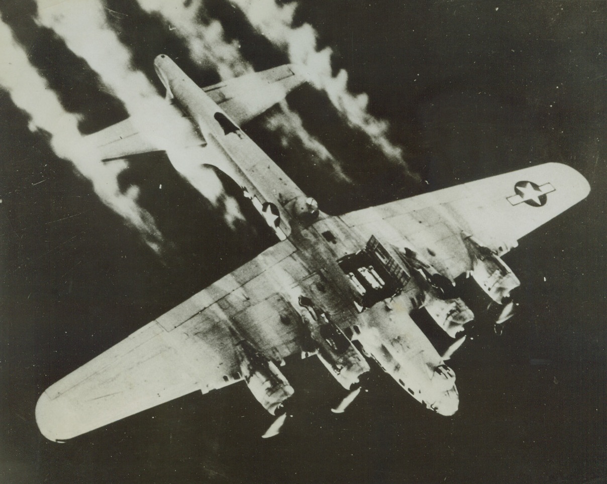 CLOSE-UP OF HITLER’S HEADACHE, 1/9/1944. GERMANY—With its bomb bay doors open, a Flying fortress streaks somewhere over Germany ready to drop its load of death and destruction on Hitler’s war-producing territory. A few second after this photo was taken, the bombs went whistling earthward to sound another note in Hitler’s death march. This remarkable picture was taken during a recent raid by U.S. Eighth Air Force Liberators and Forts.Credit: Acme;