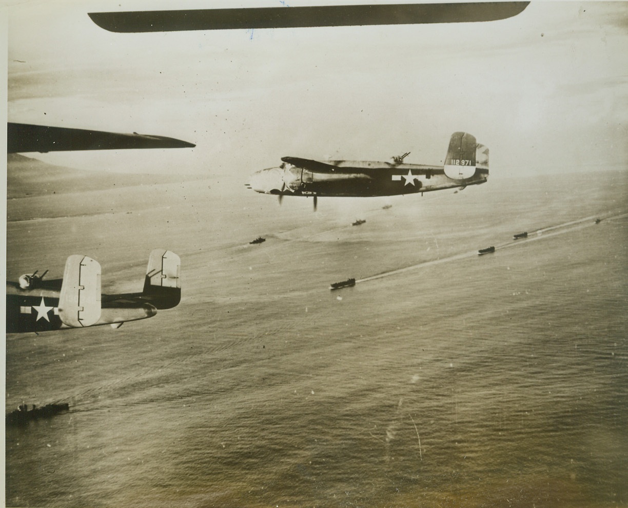 Mitchells Cover Gloucester Landing, 1/26/1944. This photo, released today in the U.S. shows B-25 Mitchell bombers of the U.S. Army 5th Air Force, covering Allied landing boats as they headed for a landing at Cape Gloucester on New Britain Island in the Southwest Pacific, Allied forces, after having neutralized Rabaul, important base on the island, are gradually closing in on the Japs there. Credit: (U.S. Army Air Force Photo from ACME);