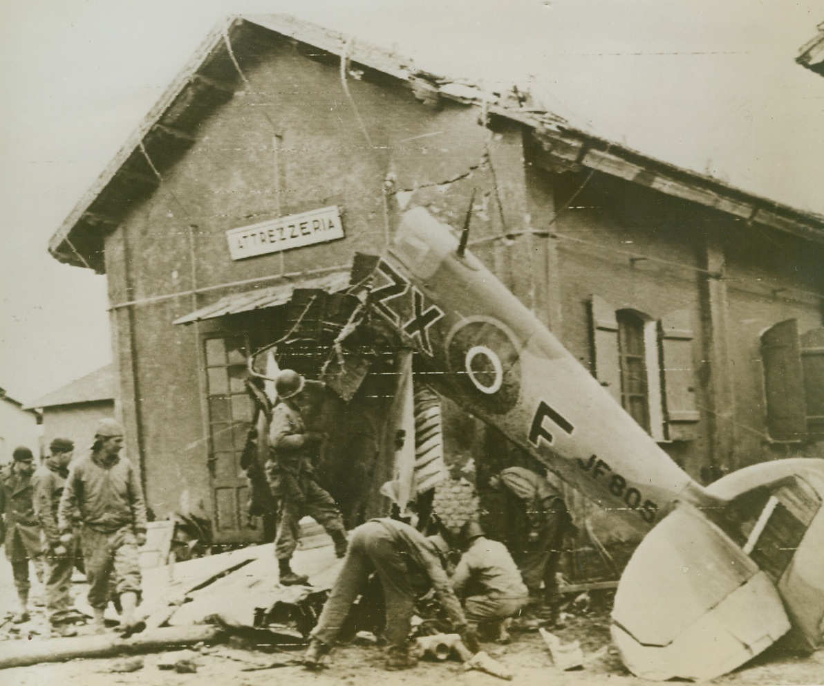 One of our Losses, 1/31/1944. WASHINGTON, D.C. – American soldiers examine the wreckage of a Spitfire which had crashed into a small building in the town of Attresseria, near Anzio, Italy.Credit (U.S. Army Signal Corps Radiotelephoto from Acme);