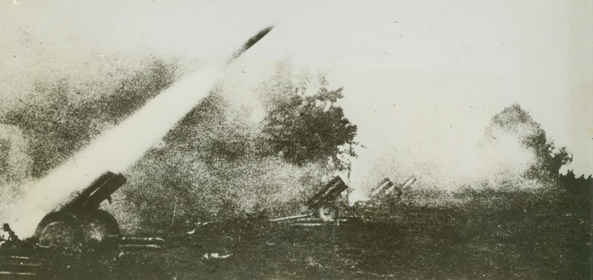 NAZI “ROCKET” BATTERY IN ACTION, 1/20/1944. An incendiary rocket shell leaves the barrel of an electrically-operated triple purpose gun, one of a battery of the German pieces “somewhere on the Russian Front.” Three other “rocket” guns can be seen in the background of the photo just received from a neutral source. Today, in spite of stiff German resistance, Soviet forces have captured Novgorod in the North and are still advancing in the Ukraine.  Credit Line (ACME);