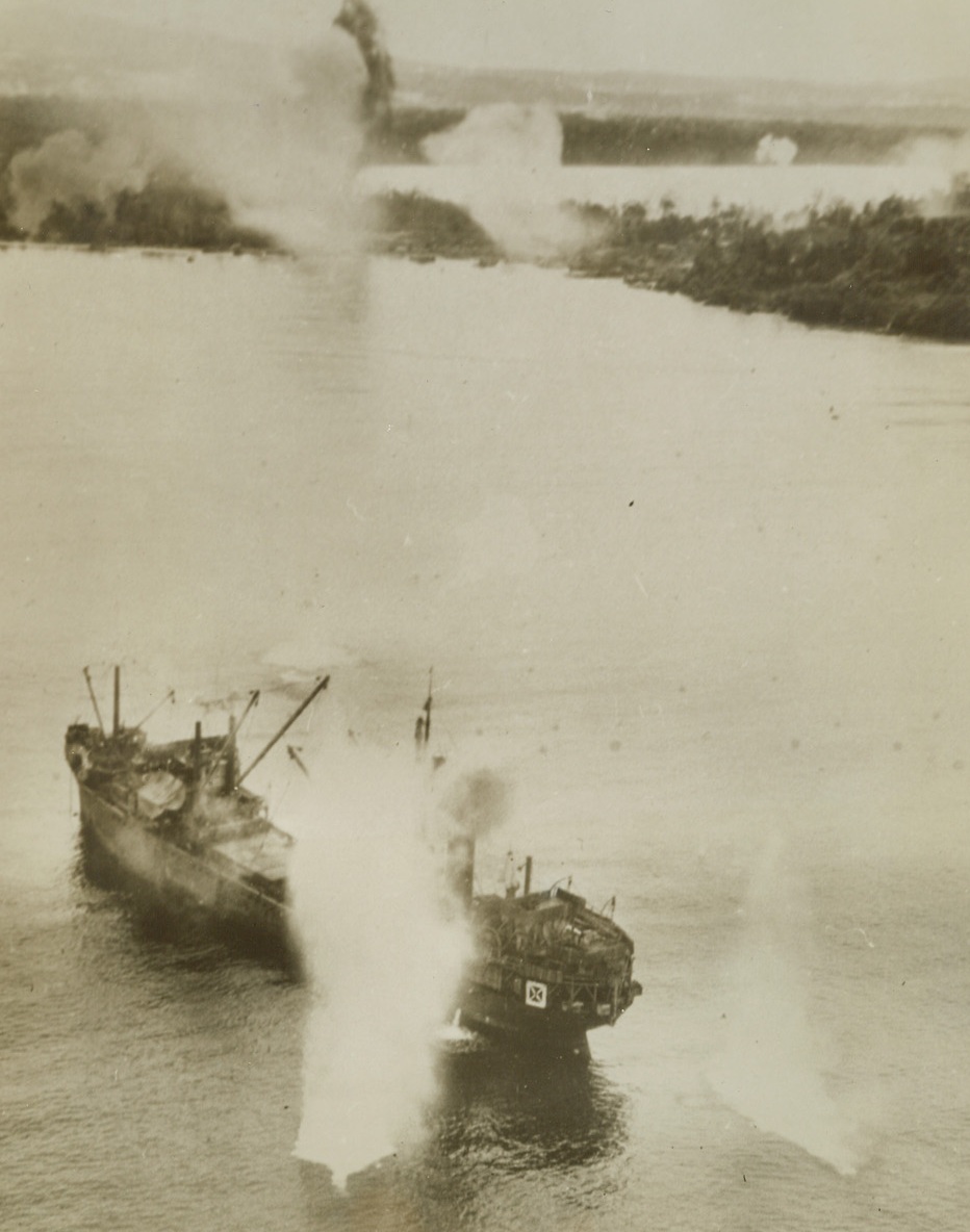 Cold Turkey, 1/27/1944. Two bombs from a plane of the U.S. Army 5th Air Force, bracket the stern of a 3,000-ton Japanese freighter caught anchored in Wewak Harbor, on the North Coast of New Guinea, during a recent raid on the Nip base. Other bomb hits can be seen along the shore installations (top of photo). American planes sank an enemy transport and a freighter in the attack. Credit: U.S. Army Air Force photo from ACME;