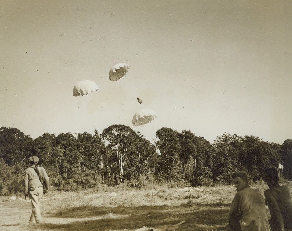 Rice for Chinese Fighters in Burma, 1/31/1941. Burma – Parachutes with large containers of rice for American-trained Chinese troops fighting on the Burma front drop from a transport plane. Note large number of chutes on the ground. (Passed by censors.)  Credit: ACME photo by Frank Cancellare for the War Picture Pool;