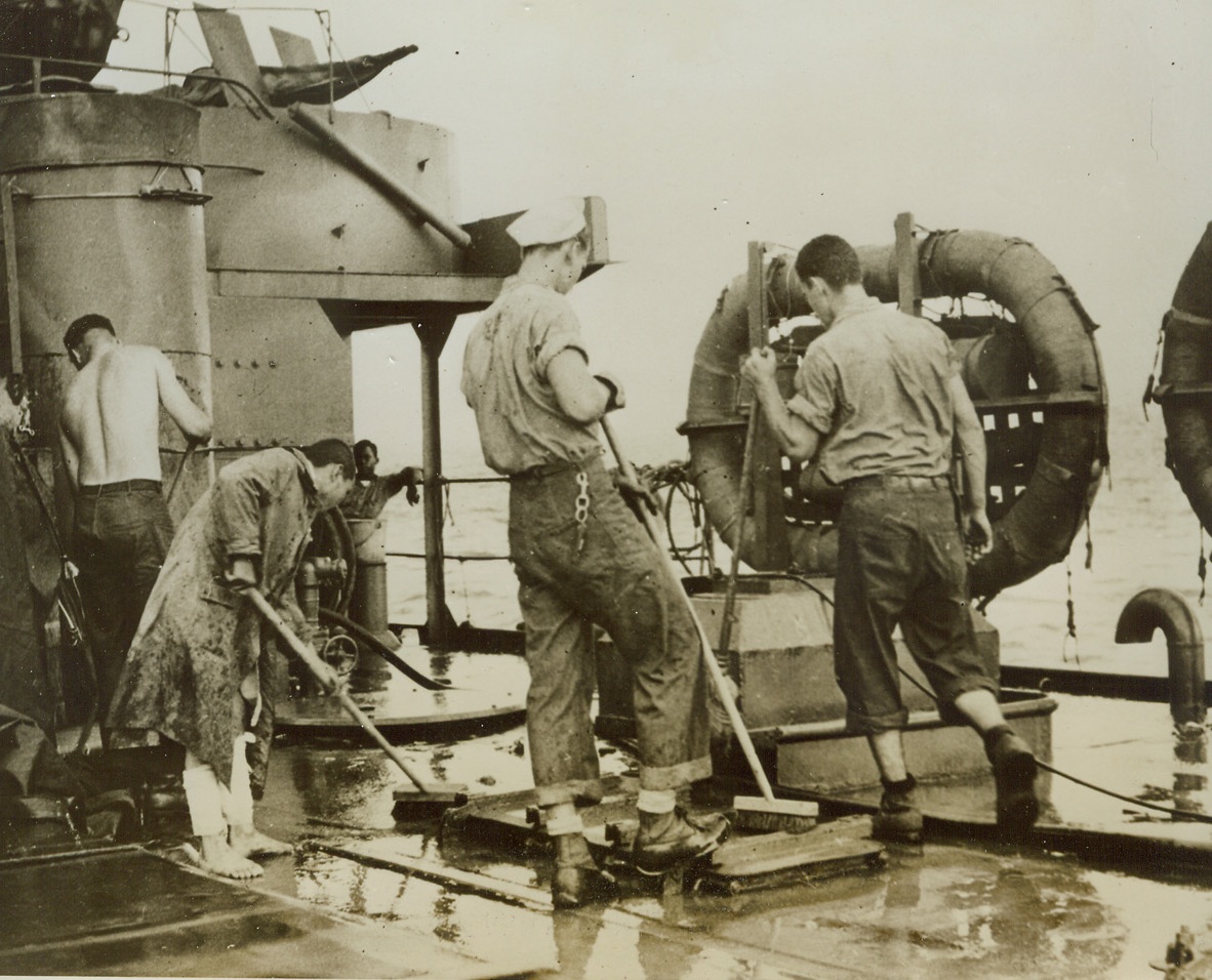 Earning His Keep, 1/26/1944. Washington, D.C:  A captured Jap helps Coast Guardsmen swab down the deck of an LST during the invasion assault at Cape Gloucester, New Britain.  He is being taken to a base camp.Credit (U.S. Coast Guard photo from ACME);