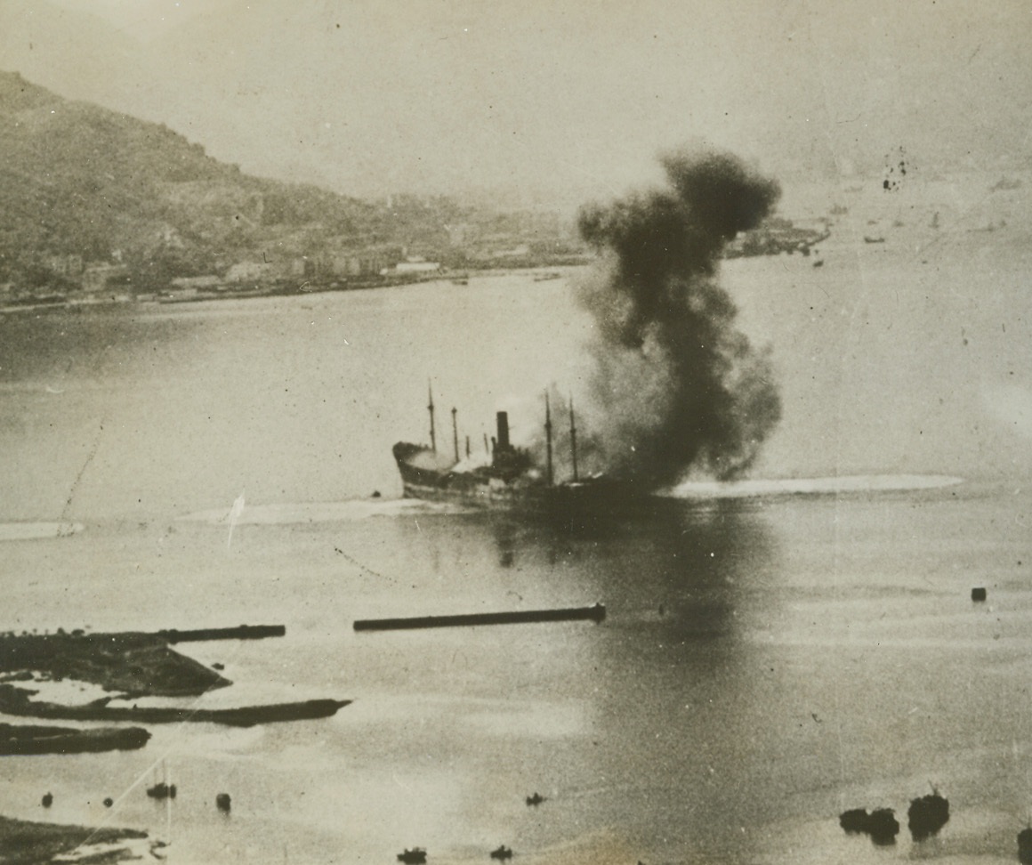 Jap ship burns in Hong Kong harbor, 1/21/1944. Hong Kong, China – Burning amidships and spouting smoke both fore and aft of the bridge, this 520-foot vessel of Japan’s rapidly dwindling merchant fleet was a victim of a 14th U.S. Air Force raid on Hong Kong harbor.  The ship was shattered by hits from B-25 Mitchells.Credit (U.S. Army Air Forces photo from ACME);