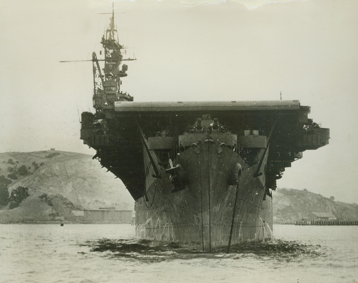 Our Newest Flattop, 1/13/1944. There’s a bow-on view of the latest addition to our Navy’s expanding flattop fleet – one of nine 10,000-ton converted cruiser carriers of the Independence class.  Combining the speed of cruisers with the deadly striking power of modern carriers, they add another hard-hitting unit to the U.S. Navy forces now blasting the enemy, and have recently delivered smashing blows to Jap bases from Wake to Rabaul.Credit Line (Official U.S. Navy photo from ACME);