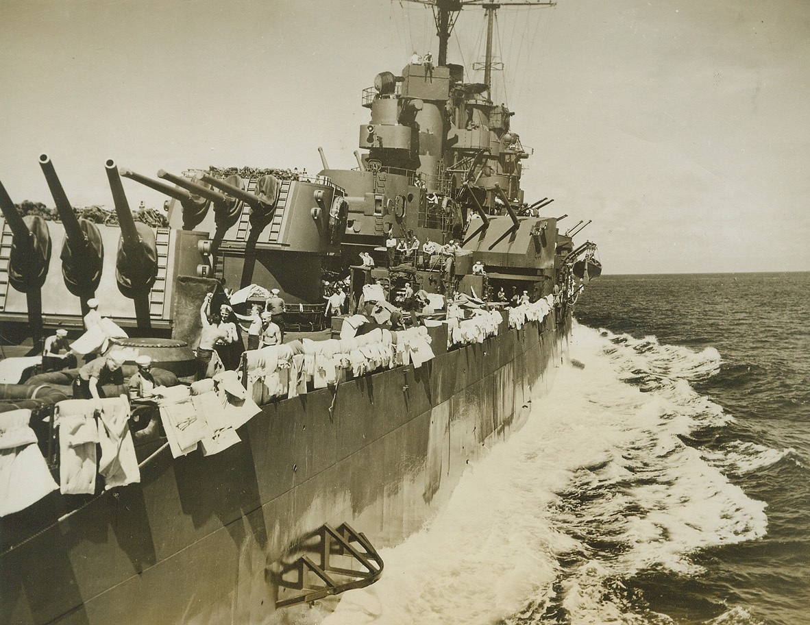 Shakedown Cruise, 1/26/1944. AT SEA -- A vital part of the training of men who fight at sea is the shakedown cruise, the run on which embryo sailors try their sea legs, get acquainted with their shipmates, and learn how to operate their ship. Navy regulations insist that bedding be aired once a week, and gobs on their shakedown cruise comply with the rules, stringing their bedding along the side. Credit: (Official U.S. Navy Photo from ACME);