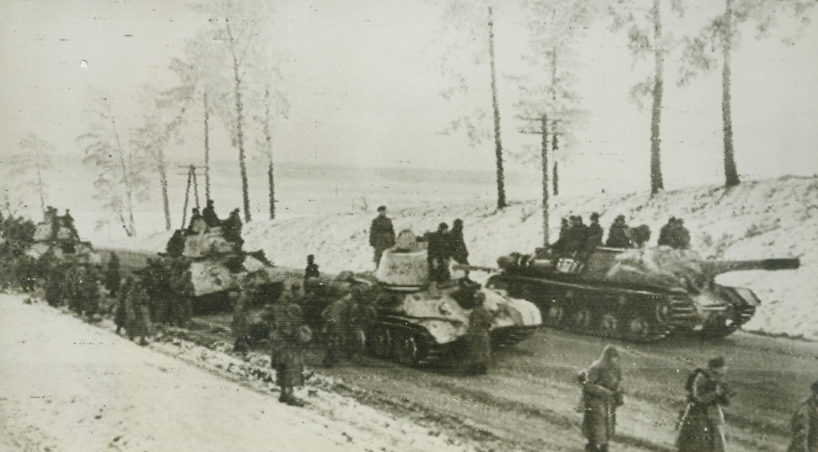 Speeding Toward Nazi Lines, 1/17/1944. UKRANIAN FRONT—Carrying tankborne infantry toward the front, Soviet self-propelled guns and tanks speed along a snow-banked Ukranian road as they chase the fleeing Nazis. Photo radioed to New York today (January 17th) from Moscow.Credit: ACME Radiophoto;