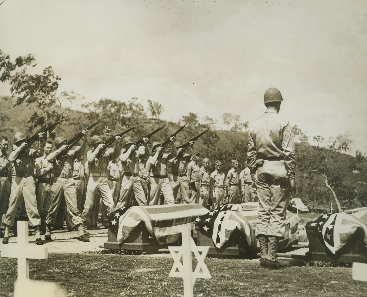 Military Funeral for Officer and Correspondent, 1/11/1944. New Guinea – A firing squad salute precedes the burial of an American officer, UP war correspondent Brydon Taves, and Harry Poague, another war newsman, who were killed in an airplane accident in New Guinea.  They are buried in the American military cemetery near Port Moresby. Credit (Official U.S. Army photo from ACME);