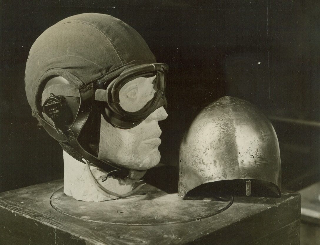 Ancient Museum Tools Make Modern Armor – 2, 1/14/1944, New York City – Tools, hundreds of years old and part of a display in the Metropolitan Museum of Art in New York city, are now being used by armorers at the museum to create body and head armor for American fliers of World War Two.  The Metropolitan Museum was chosen for this work, which began last August, because it boasts the largest collection of ancient armorer’s tools in the world.  The work of experimentation and improvement of body armor and helmets worn by aircraft crews goes on behind a steel door, in strictest privacy.  Here is the skull cap of cloth, which is worn under the modern aviator’s helmet developed by the museum.  At right is an Italian helmet of first half of the fifteenth century. Credit line (ACME);