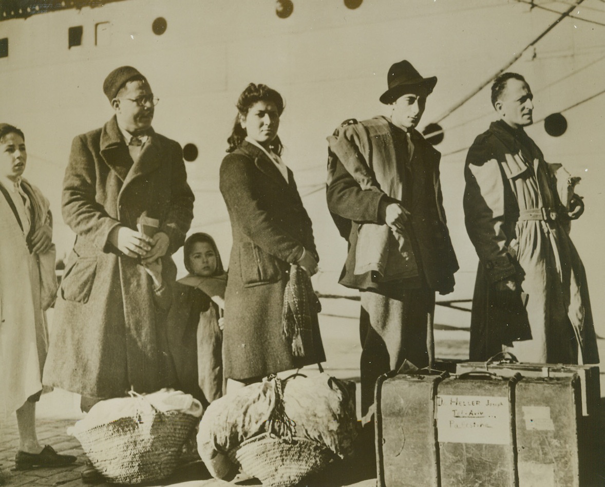 Heading For a New Home, 1/28/1944. North Africa – Jewish refugees line up on a dock in North Africa, awaiting their turn to embark for Palestine where they will become agricultural settlers. Through the cooperation of the American Jewish Joint Distribution Committee, British authorities and the American Office of Foreign Relief, they will find a new freedom. Credit line (ACME);