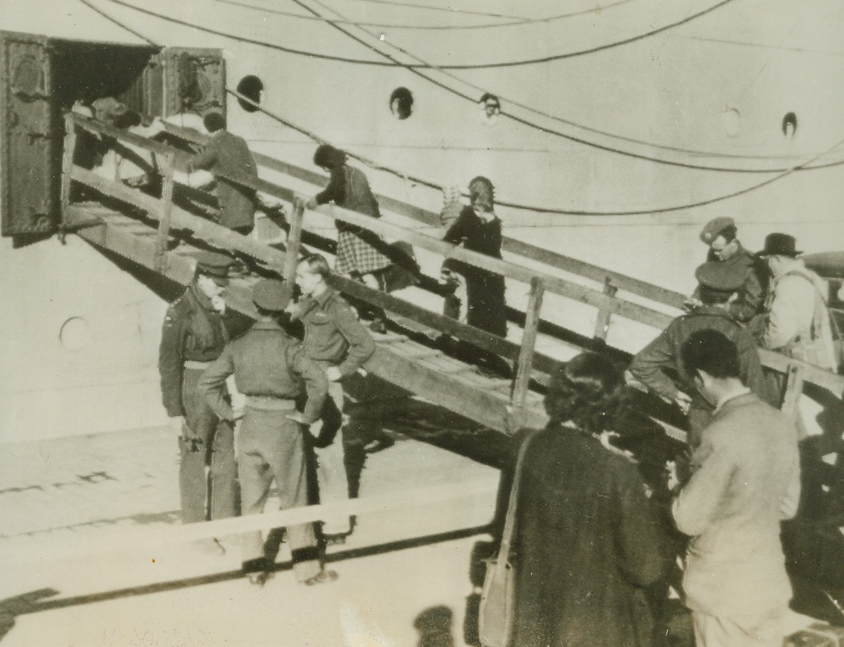 Heading for a New Freedom, 1/10/1944. A North African Port—These refugees, left homeless by Hitler’s ruthless advance in European countries, climb up the gangway of a ship at a North African port. They will be taken, with others, to Palestine where they will be given the opportunity to establish themselves as agricultural settlers. Credit: OWI radiophoto from ACME.;