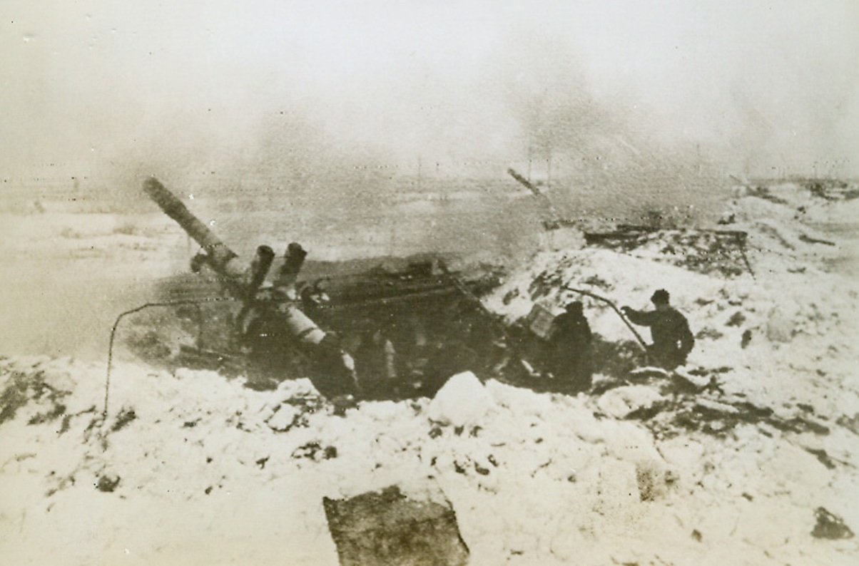 Soviets Rip Nazi Defenses at Leningrad, 1/22/1944. Russia—Heavy Russian guns blast Nazi fortifications near Leningrad, tearing holes in the mighty fortress built during the two-and-a-half year Nazi possession of the Soviet second city. The Russian caption says that “tens of thousands” of Germans have been killed in this area, where the capture of key rail junctions cuts off the escape of thousands more. Credit: ACME radiophoto.;