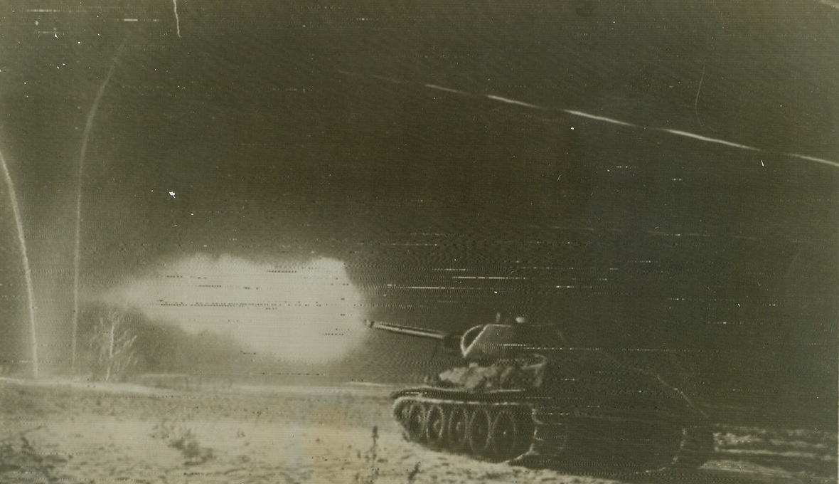 Red Tanks Battle Night and Day, 1/16/1944. Ukraine—A Soviet tank makes a spectacular picture as it fires on enemy positions at night on the first Ukranian front. Red Army troops have killed more than 100,000 Germans in 21 days of fighting on that front and in the past 24 hours have advanced five miles into German lines. Credit: ACME radiophoto;
