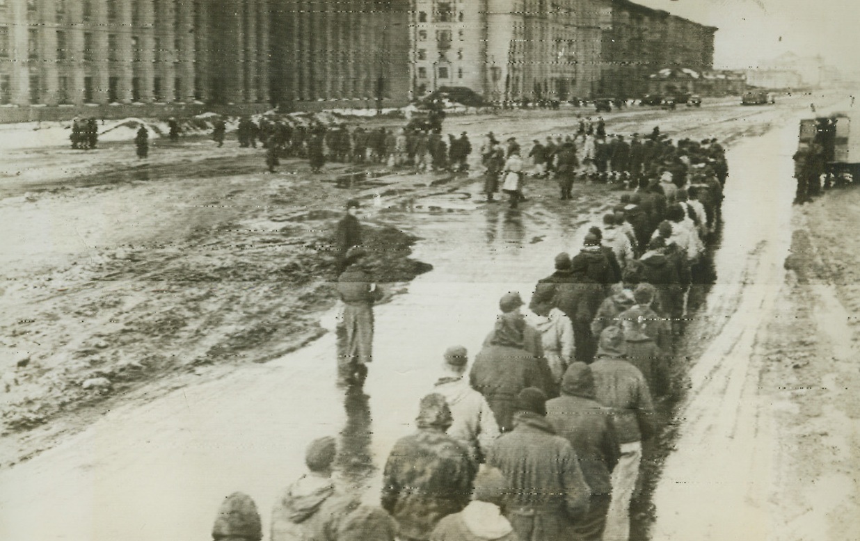 Defeat in the East, 1/30/1944. Leningrad—Symbolic of the defeat that the much-vaunted German Wehrmacht is suffering in the East is this long line of Nazi war prisoners in Leningrad who were taken when the lengthy siege on that city was lifted recently. What’s left of Germany’s battered armies are reported to be fleeing into Estonia through a 30-mile bottle-neck between the Gulf of Finland and Lake Peipus as Russian troops, advancing more than 10 miles a day, swept to the approaches of that Baltic state. Credit: ACME radiophoto;