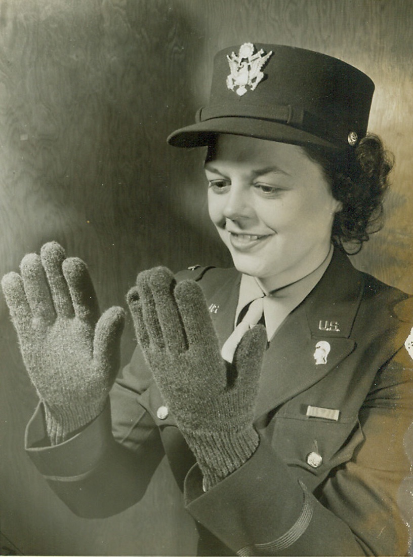 Left or Right Handed?, 1/12/1944. Chicago—You can’t tell the left from the right in these new Army issue gloves because they’re “ambidextrous,” says the Army quartermaster depot in Chicago. Wac Lt. Elfrieda Heideman wears the gloves in which the thumbs are knitted in a straight line with the other digits so that the glove fits either hand. The ambidexterity lessens replacements, too, says the Army, for only one glove has to be replaced instead of a pair, should a glove wear out or be lost.Credit: ACME.;