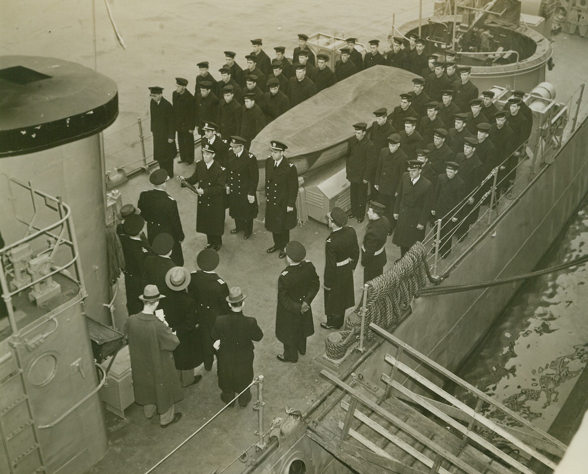 Honoring Sub Chaser, 1/26/1944. New York City—A memorial plaque honoring the officers and men who lost their lives when the submarine chaser, USS SC-209, went down during World War I, was presented to the USS PC-565 today (January 26th). The vessel honored was the first of the 110 foot patrol chaser class to distinguish itself by outstanding action against the enemy in World War II. Here is a general view of the ceremonies as Lt. Charles P. Sheppard, captain of the PC-565, accepts the plaque, which was offered to the Navy by H. Liggett Gray, a member of the SC-209 crew who was not aboard when the vessel went down. Credit: ACME.;