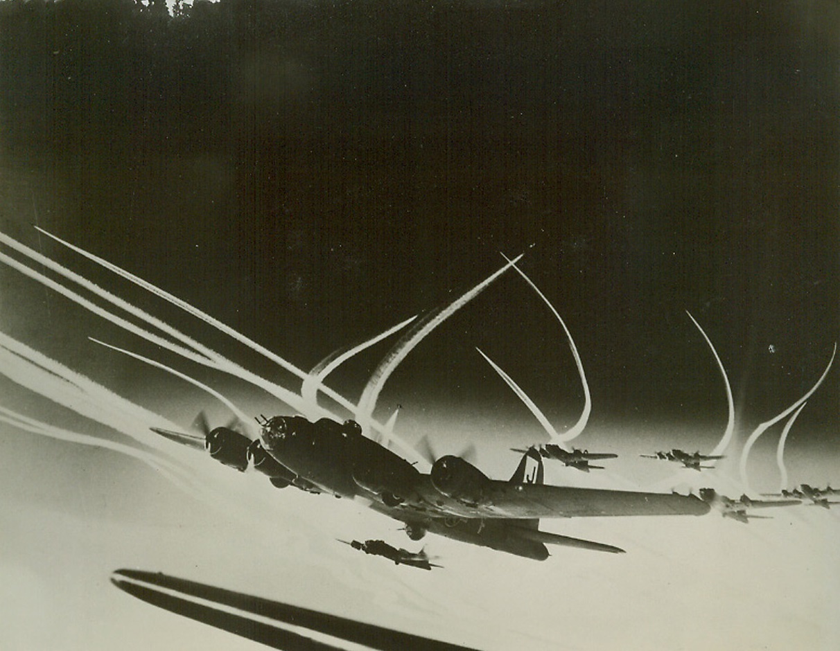 Deadly Sky Writers, 1/20/1944. Leaving white vapor trails high in the sub-stratosphere, these planes of the U.S. Army 8th Air Force head for another devastating raid on Hitler’s “Fortress Europa.” In the foreground, are Flying Fortresses, while in the background, fighters accompanying the bombers on the mission leave curved trails in the sky. Credit: U.S. Army Air Forces photo from ACME;
