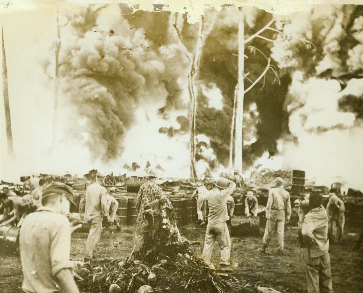 Leathernecks save fuel from Jap bomb fire, 1/11/1944. PURUATA ISLAND – United States Marines roll out unexploded drums of fuel from within 30 feet of hungry pillars of fire, set off by a Jap bomb hit on Puruata Island. Thousands of drums, wet down by hose lines, were saved by the leathernecks fighting in the Bougainville Area. Two heat prostration cases were the only casualties in the “battle” with a flaming enemy. CREDIT (Official U.S. Marine Corps photo – ACME) 1/11/44;